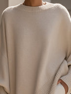 Cream-beige oversized knit sweater with crew neck and ribbed cuff detail