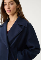 Navy boxy cropped blazer close-up with notched lapel and double-breast buttons
