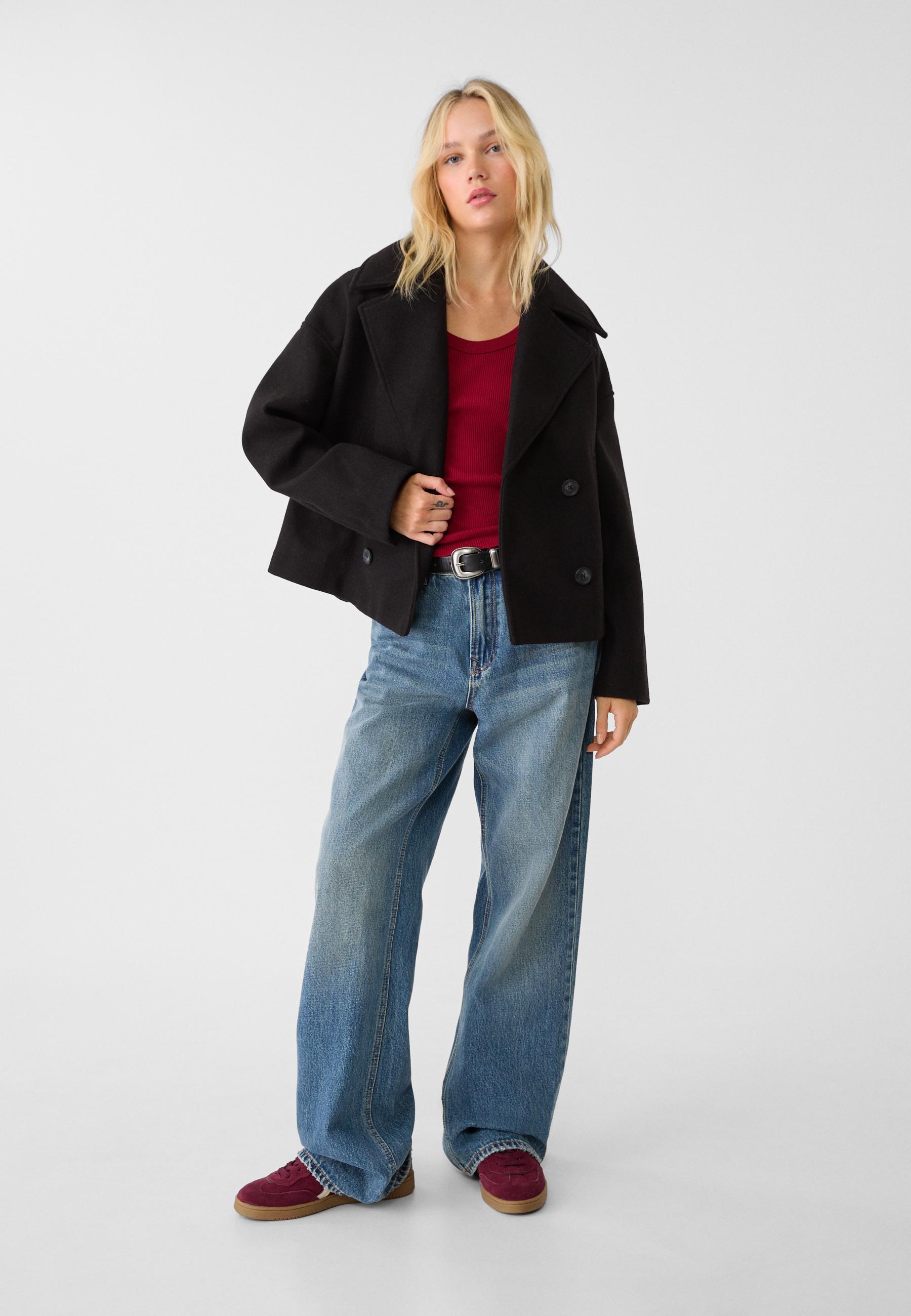 Black double-breasted cropped blazer, boxy fit, notched lapels, long sleeves
