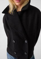 Black boxy cropped double-breasted blazer close-up with notched lapels