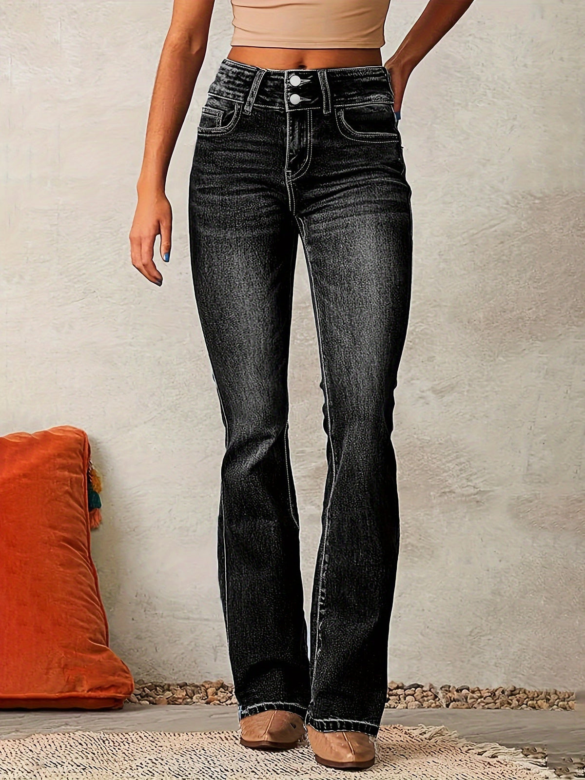 Black high-waisted flared jeans, front view with button fly and seam detailing