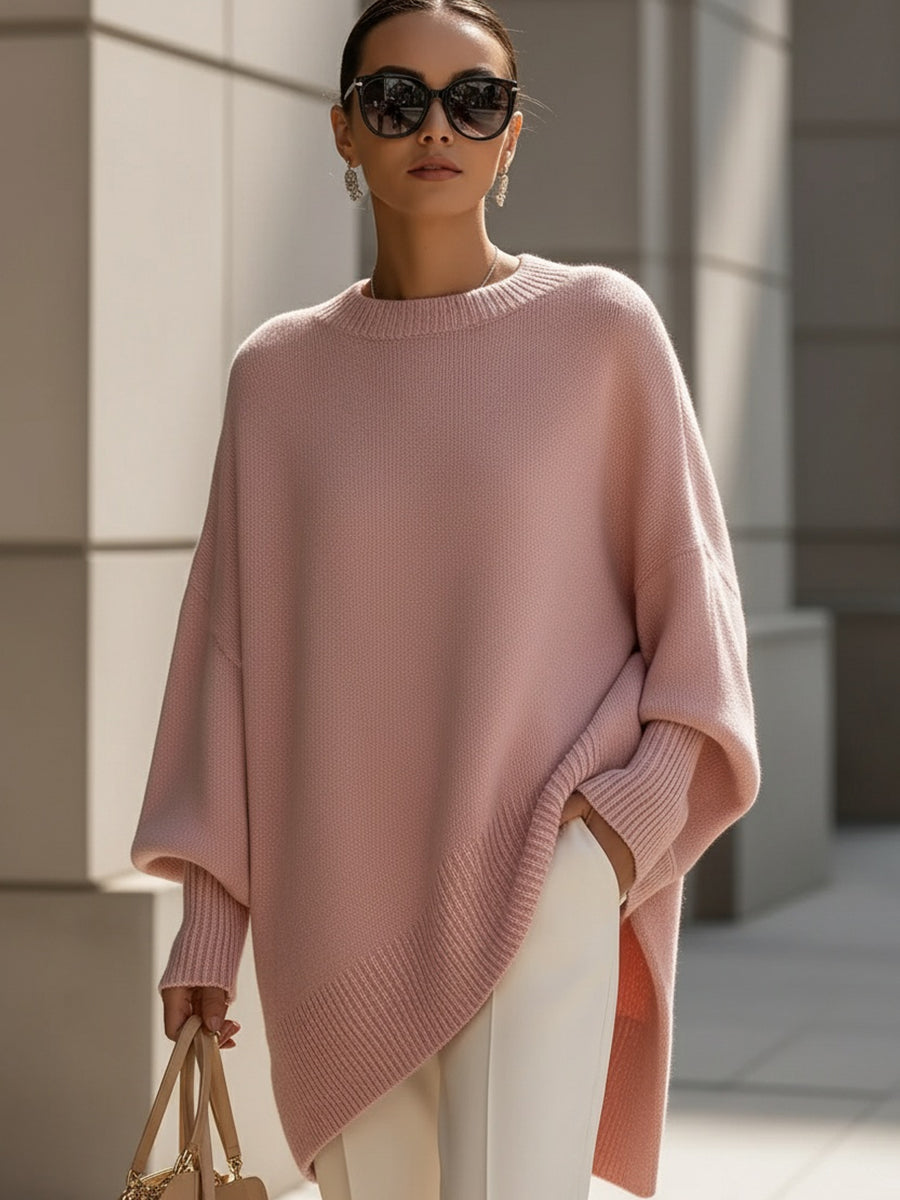 Blush pink oversized knit poncho with ribbed crew neck and draped side