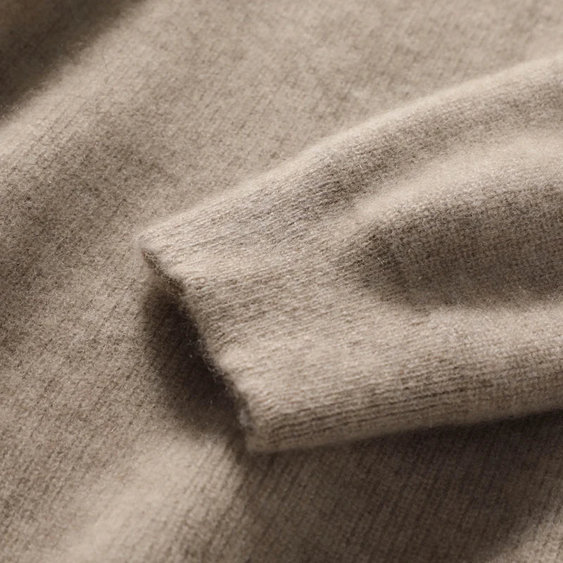 Heathered knit fabric close-up on a women’s pullover hoodie in warm taupe