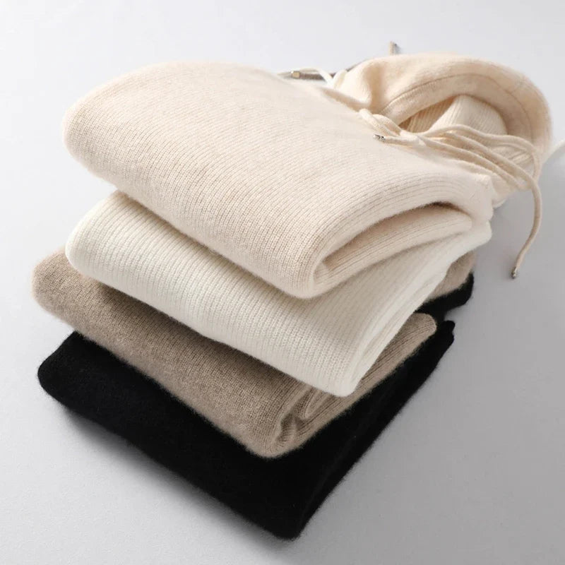 Folded women’s pullover hoodies with drawstrings and ribbed cuffs in light neutrals
