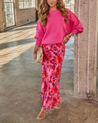 Hot pink oversized knit sweater with crew neck, ribbed cuffs, and relaxed drape.