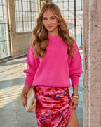 Hot pink oversized knit sweater with crew neck and ribbed cuffs, relaxed fit.