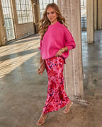 Hot pink oversized knit sweater, crew neck, dropped shoulders, ribbed cuffs.