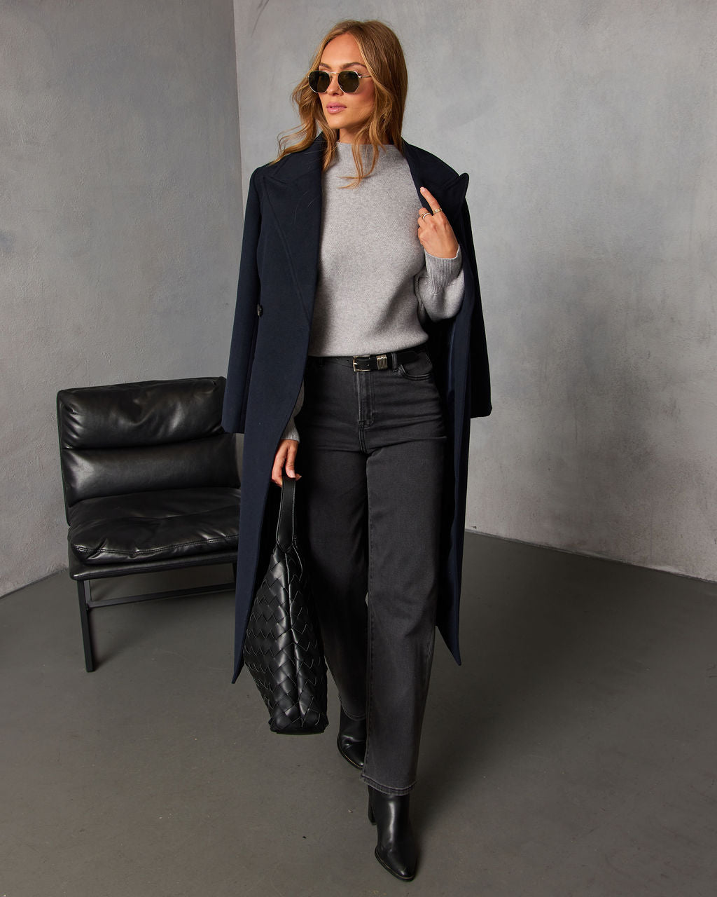 Black mock neck sweater with long sleeves and high neckline