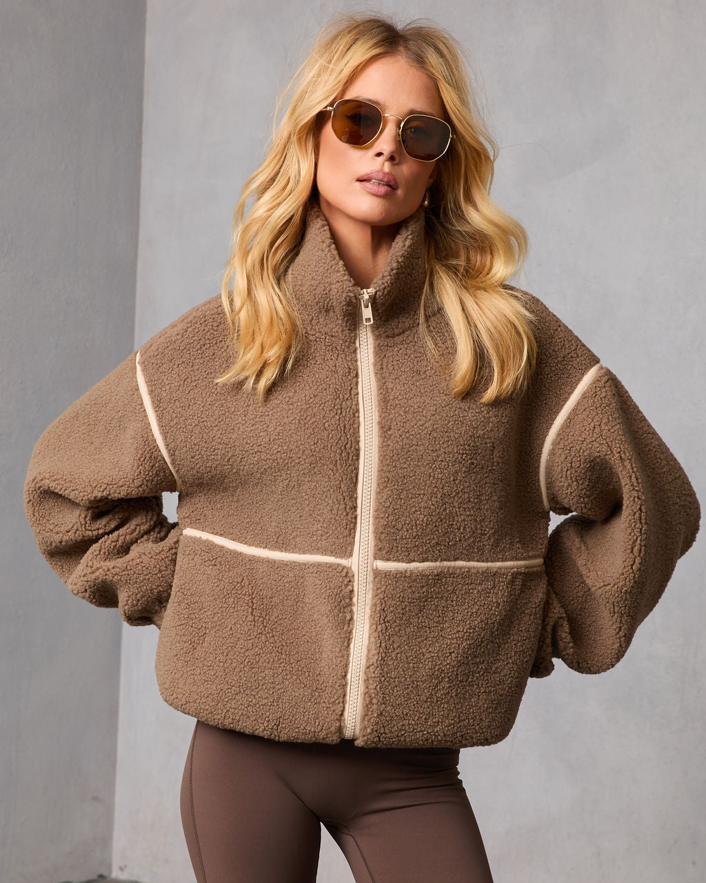 Brown hooded shearling jacket with contrast trim and front zipper