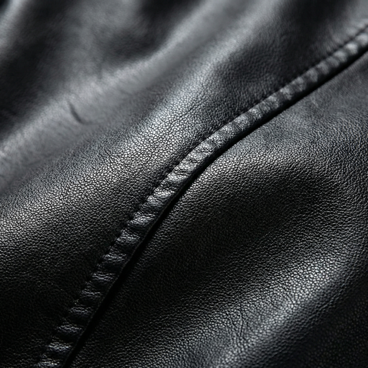 Black leather biker jacket, stitched seam and zip placket detail