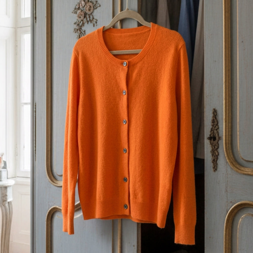 Orange merino wool cardigan with button-front, ribbed crew neckline, long sleeves