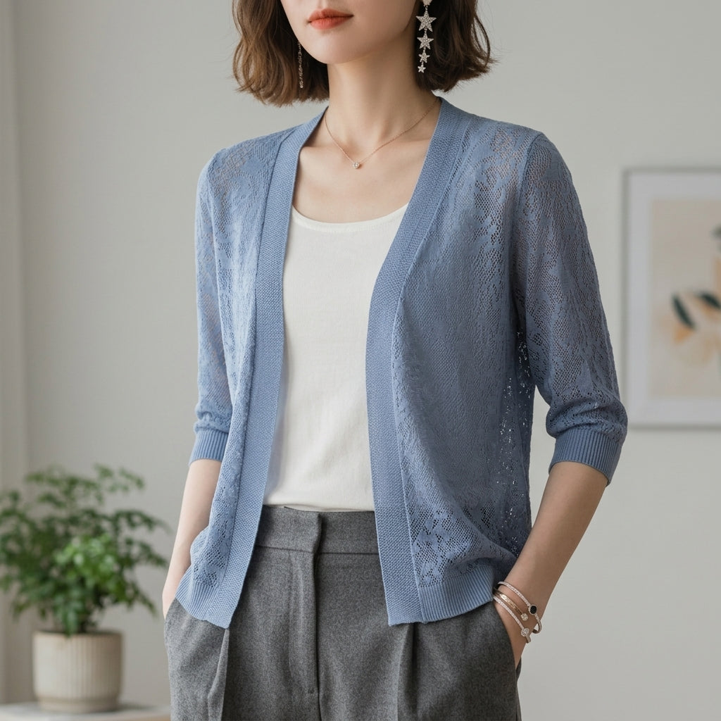 Cropped lace knit cardigan with half sleeves and openwork lace pattern in light blue