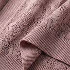 Cropped lace knit cardigan with openwork lace panels and ribbed cuff detail in light pink