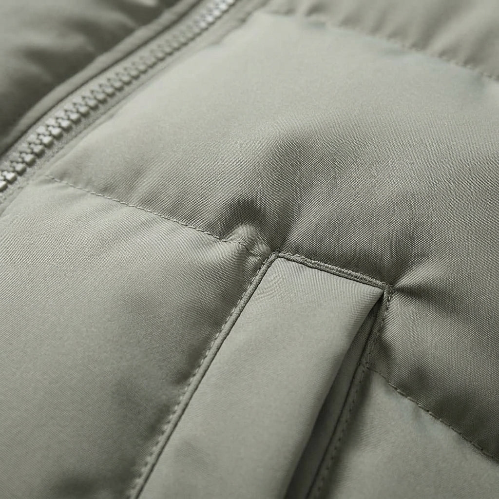 Light grey hooded puffer jacket with stitched panels and seam details