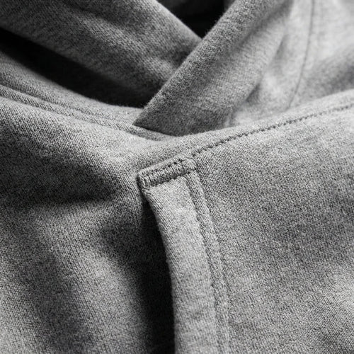 Grey oversized hoodie sleeve cuff seam and pocket opening detail