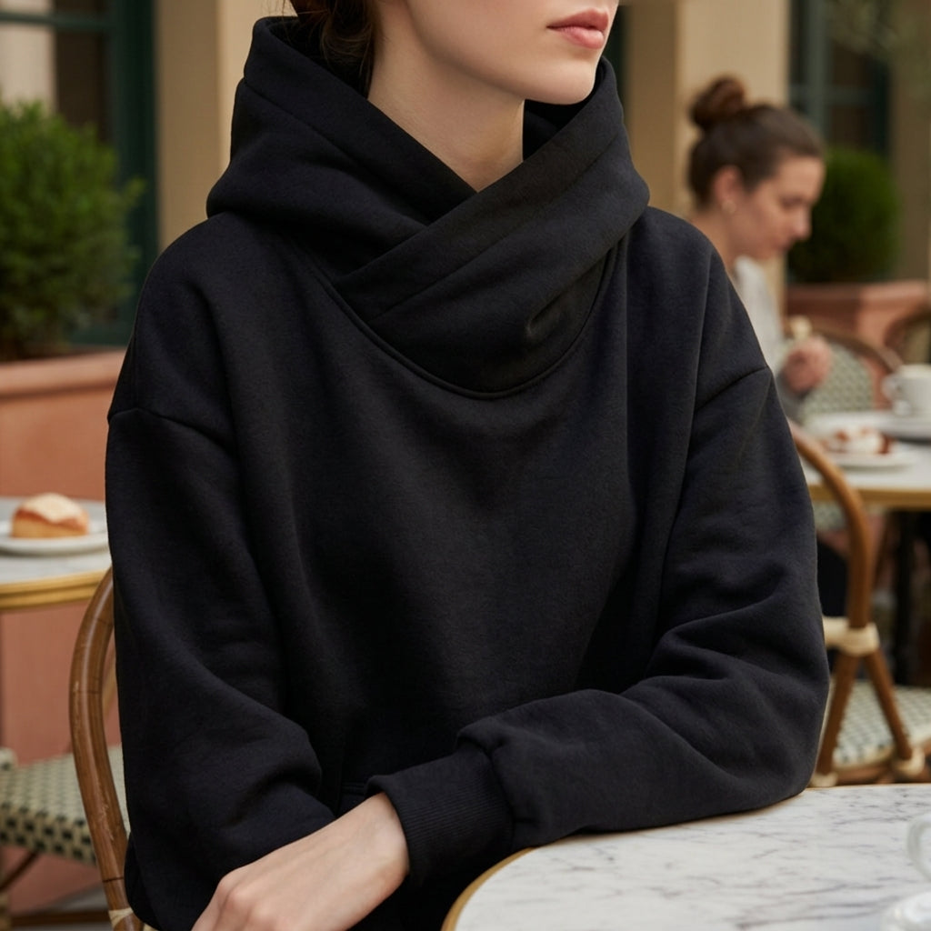 Black oversized hoodie with front kangaroo pocket and hood, worn by model