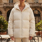 Light beige hooded puffer jacket with full-zip front and ribbed cuffs