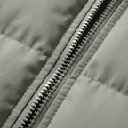 Hooded puffer jacket zipper detail with textured pull tab