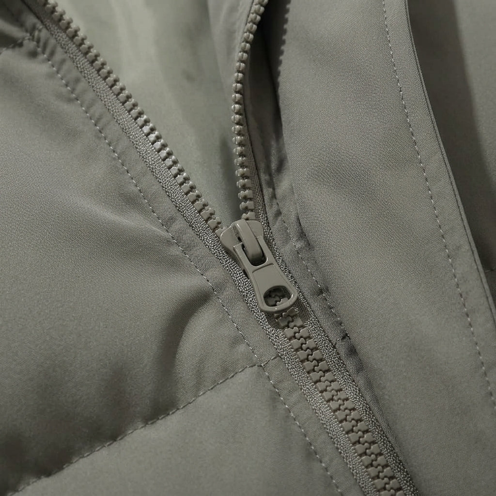Hooded puffer jacket front zipper with metal pull and stitched panels