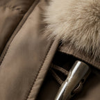 Brown puffer jacket with faux fur collar and side flap pockets.