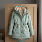 Light green lined-hood parka with front zipper, snap buttons, and drawstring waist