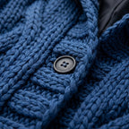 Blue knit coat collar area with hood seam and round button detail