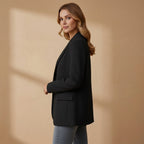 Women’s black blazer with notched lapel, single-breast front, long sleeves, flap pockets