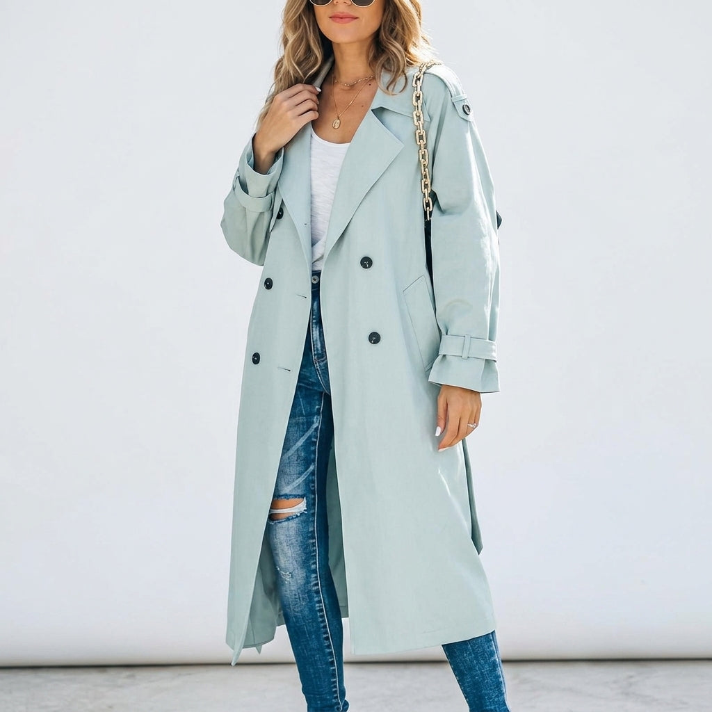 Long light blue trench coat with double-breasted buttons and notched lapels, flap pockets