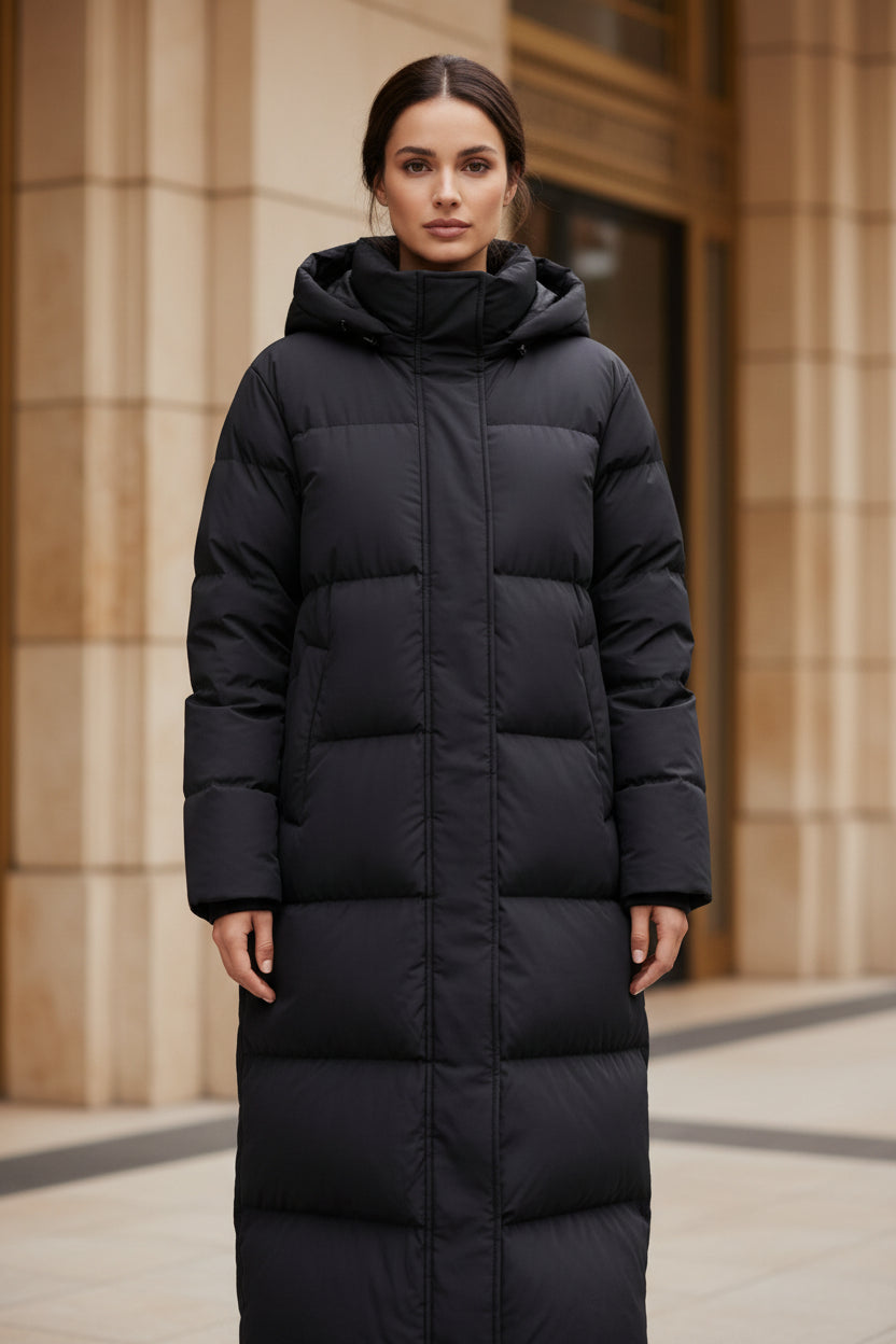 Women's long black hooded quilted puffer parka with front zipper and side pockets