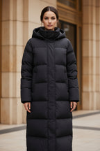 Women's long black hooded quilted puffer parka with front zipper and side pockets