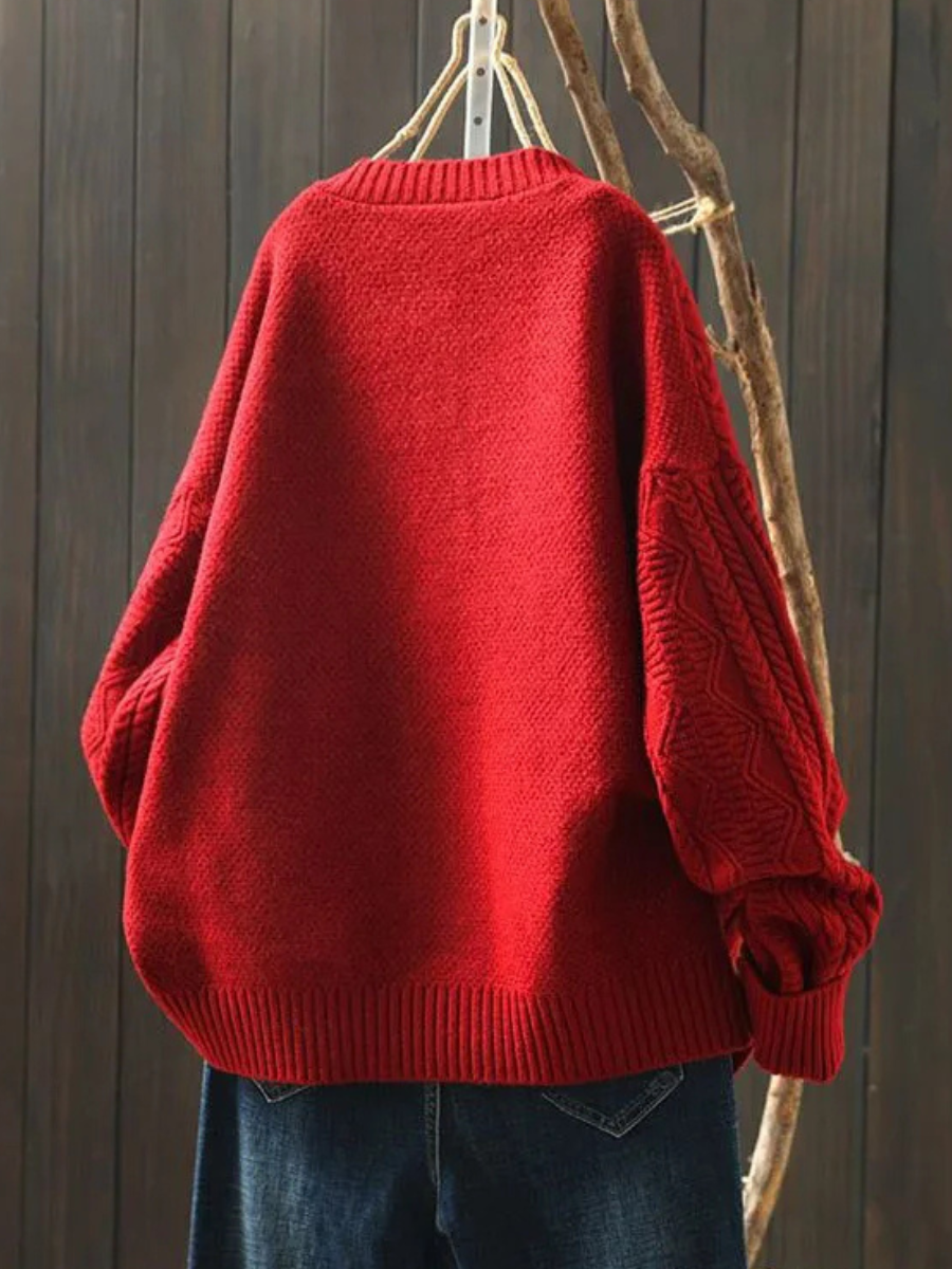 Red cable-knit cardigan with button front and ribbed cuffs