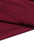Close-up of wine red fabric seam with stitched trim along the waistband