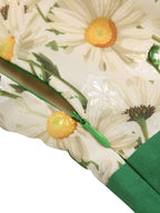 Floral print fabric detail with green zipper tape along seam and daisy illustration