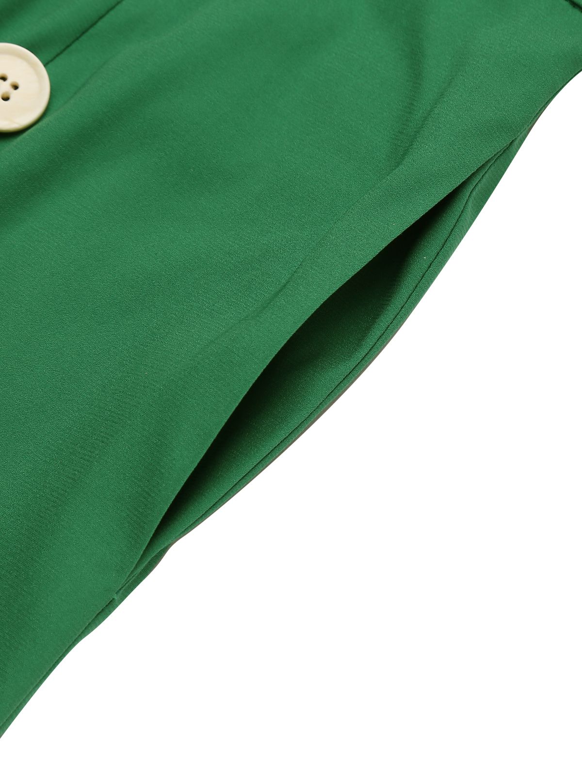 Green romper fabric close-up with button at bodice edge and folded seam detail
