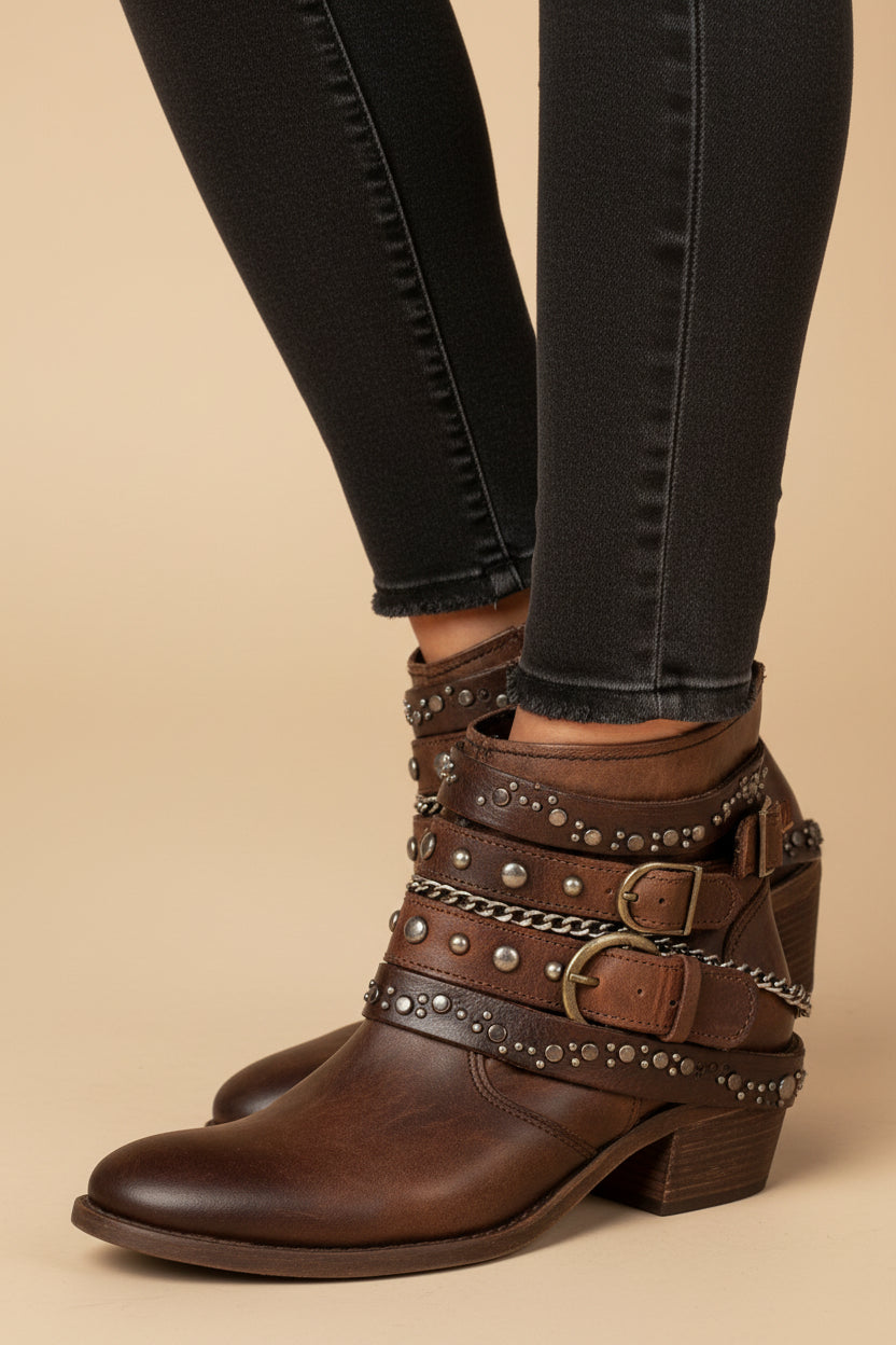Brown vintage ankle boots with studded straps and buckled side and toe details