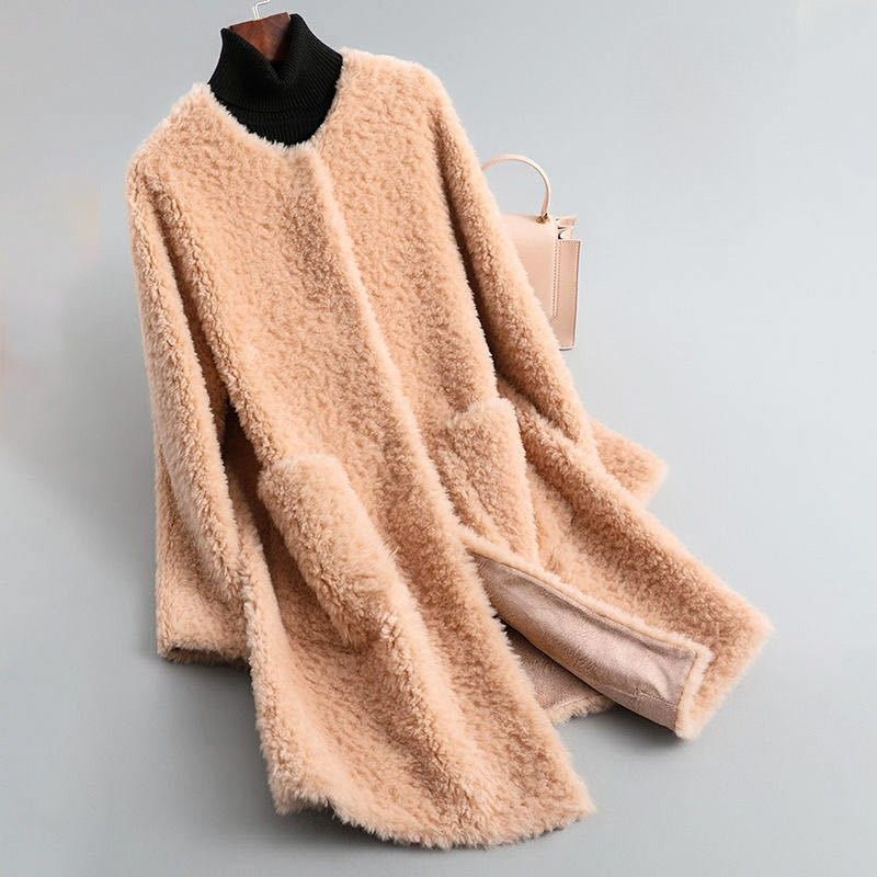 Light pink shearling coat with ribbed black turtleneck, long sleeves, curved hem