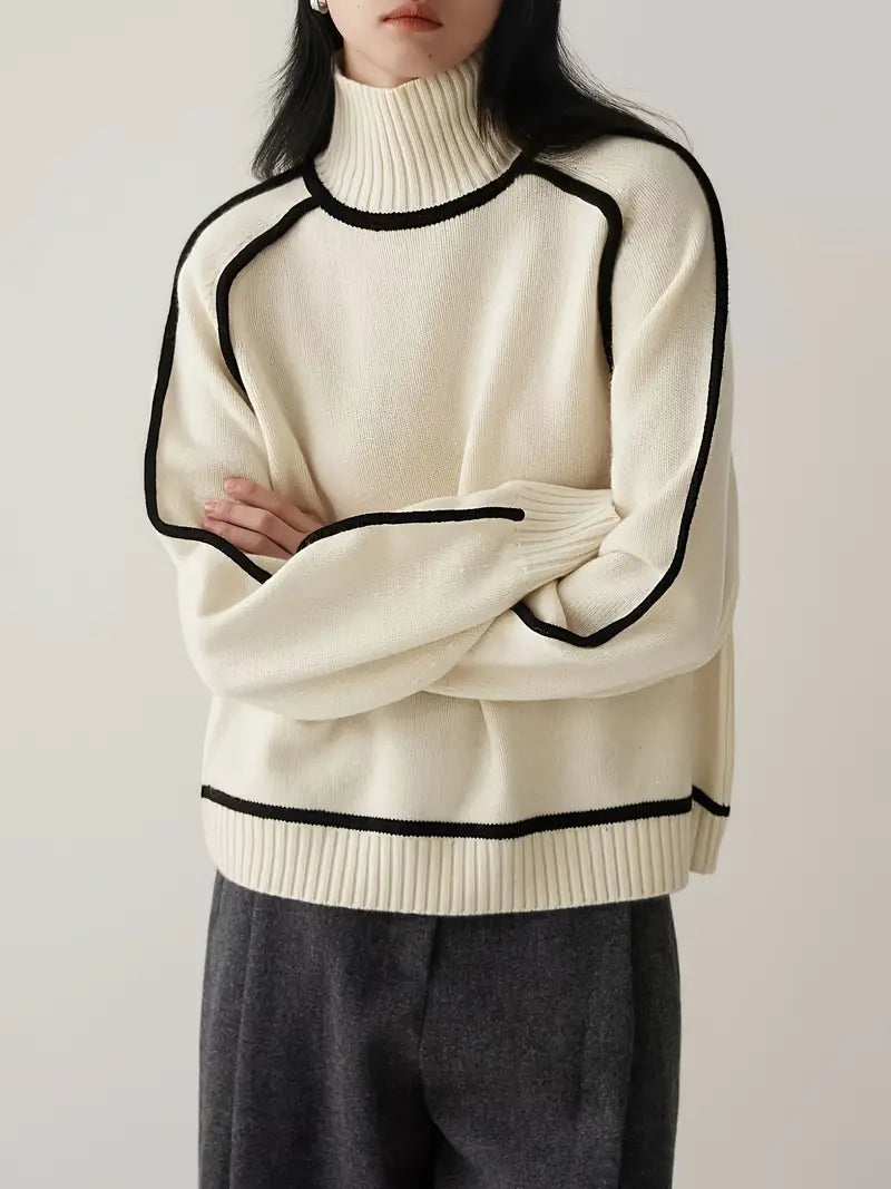 Cream turtleneck knit sweater with black trim at neck, hem, and sleeves
