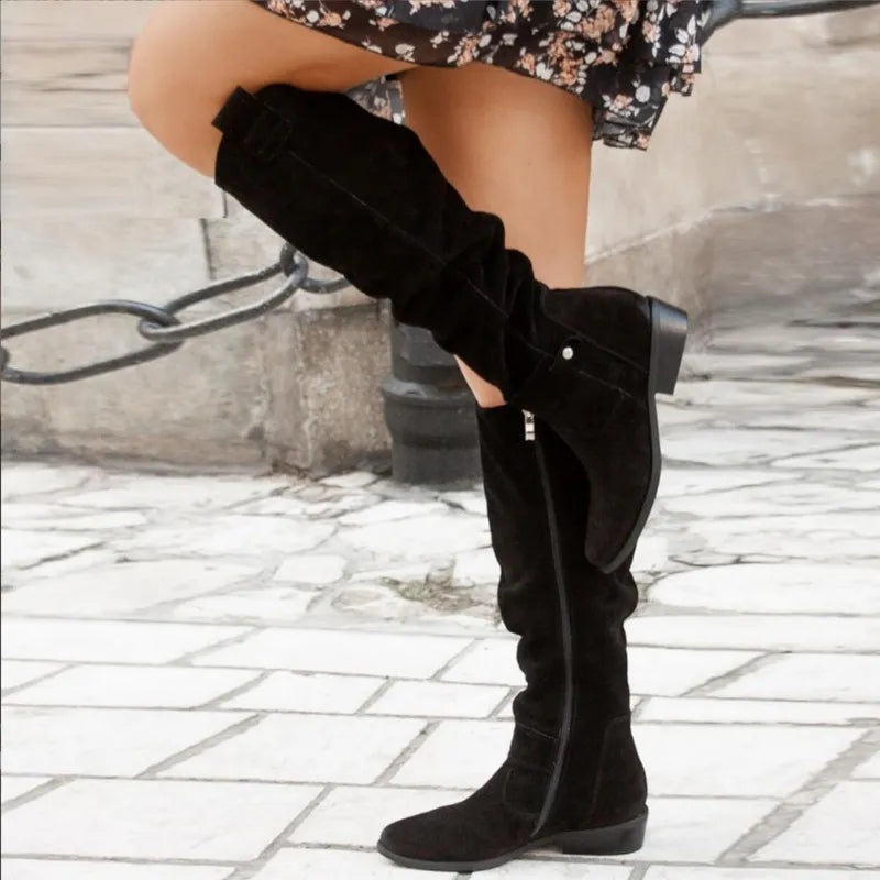 Women’s black suede ankle boots with stacked heel and side pull tabs