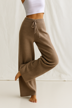 High-waisted wide-leg lounge pants in dark brown tan with drawstring waistband and cuffed hem