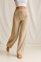 High-waisted wide-leg lounge pants in taupe tan, adjustable drawstring waistband