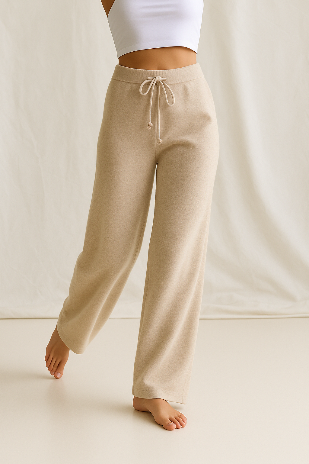 High-waisted wide-leg lounge pants in light tan, drawstring waistband and relaxed straight legs
