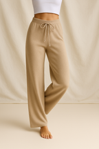 Camel high-waisted wide-leg lounge pants with drawstring, worn with bare feet.