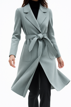 Womens long belted overcoat in dusty light blue with notched lapels and waist tie
