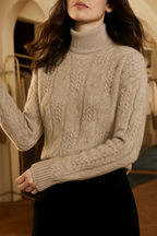 Light beige cable knit mock neck sweater with long sleeves and ribbed neckline