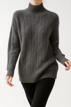Charcoal gray cable knit mock neck sweater with long sleeves and ribbed hem