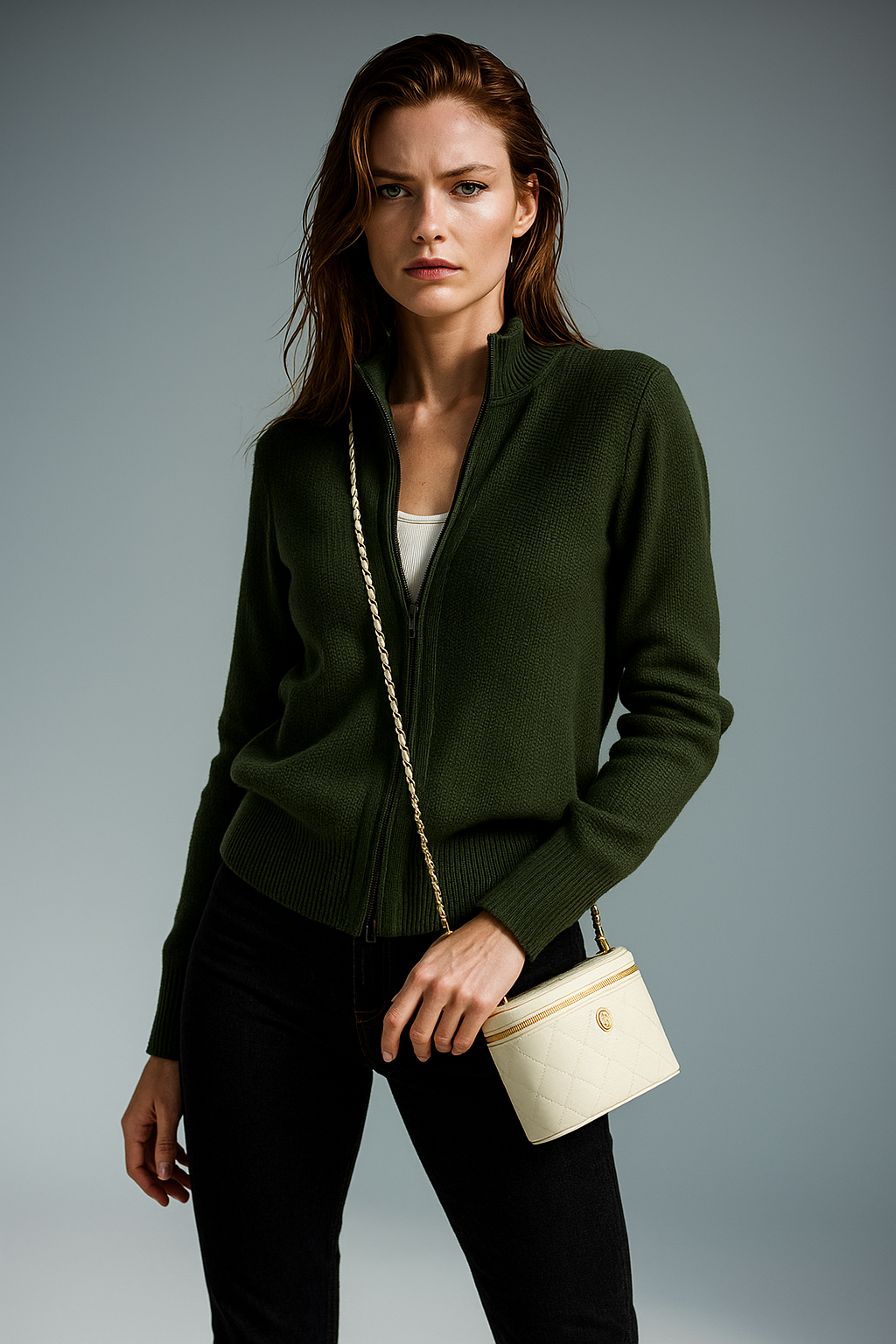 Dark green zip-up cardigan with ribbed knit, stand collar, and front zipper