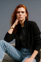 Black zip-up cardigan sweater with textured knit and ribbed cuffs, front zipper.