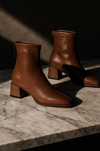 Tan-brown leather ankle boots with square toe, side zip pull, block heel.