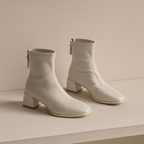 Ivory women's square-toe ankle boots with side zip and block heel, angled view