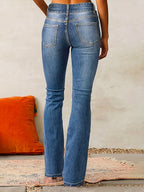 Denim blue high-waisted flared jeans, back view with belt loops and rear pockets